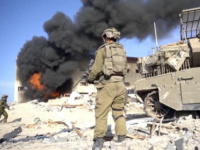 PHOTO: Image taken from a video released by the Israeli Defense Forces on Nov. 14, 2023. An Israeli soldier holds a weapon in Gaza City.  (Israel Defense Forces via AP)
