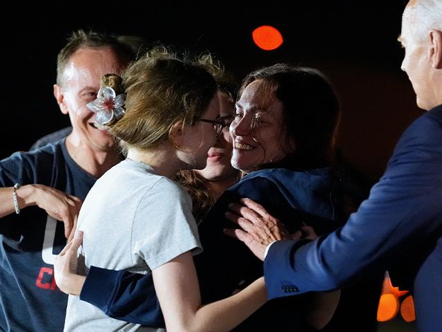 PHOTO: President Biden interrupts Alsu Kurmasheva, who is hugging her daughters Bibi Butorin, Miriam Butorin and husband Pavel Butorin, after the prisoner swap with Russia, Aug. 1, 2024. (AP Photo/Alex Brandon)