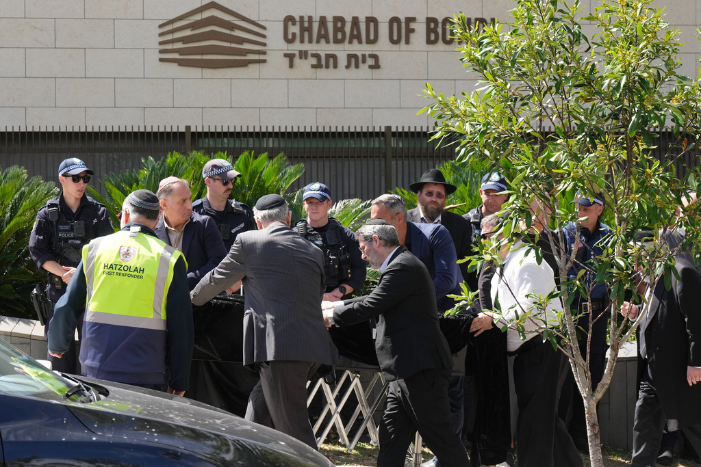  A coffin is wheeled into a synagogue in Bondi on Wednesday, Dec. 17, 2025, in Sydney, Australia, before the funeral of Rabbi Eli Schlanger, a victim in the Bondi Beach mass shooting. (AP Photo/Mark Baker)