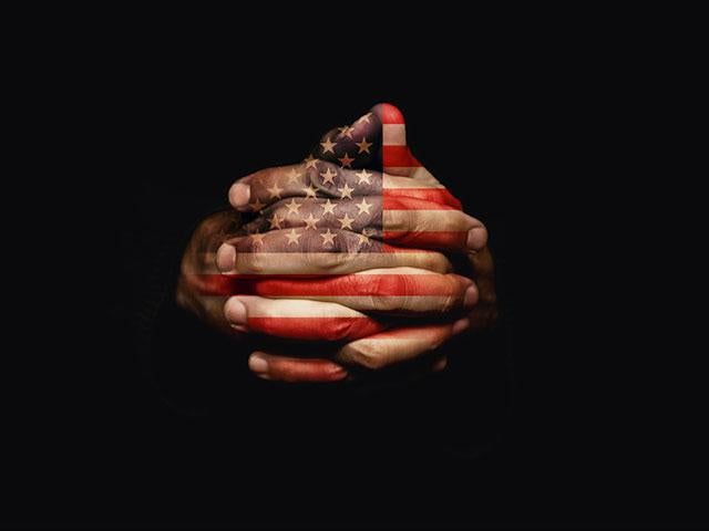 American flag on praying hands