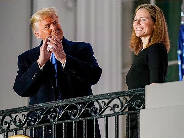 President Donald Trump applauds Amy Coney Barrett after she took her Constitutional Oath for the Supreme Court at the White House, Oct. 26, 2020. (AP Photo/Patrick Semansky)
