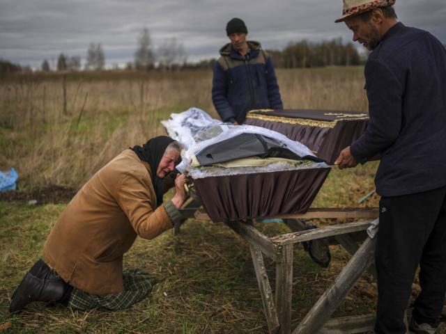 Nadiya Trubchaninova cries over the coffin of her son, Vadym, who was killed on March 30 by Russian soldiers in Bucha, Ukraine, during his funeral in the cemetery of nearby Mykulychi, on the outskirts of Kyiv, on April 16, 2022. 