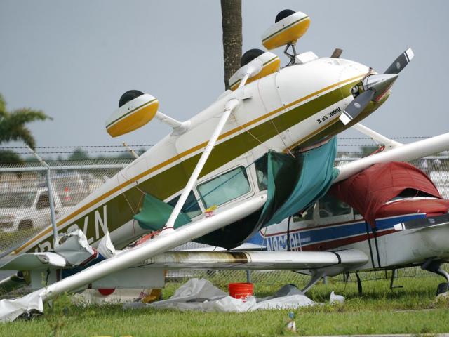 An airplane overturned by a likely tornado produced by the outer bands of Hurricane Ian, Sept. 28, 2022, at North Perry Airport in Pembroke Pines, FL (AP Photo/Wilfredo Lee)