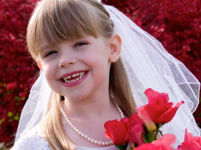 little girl dressed up as a bride