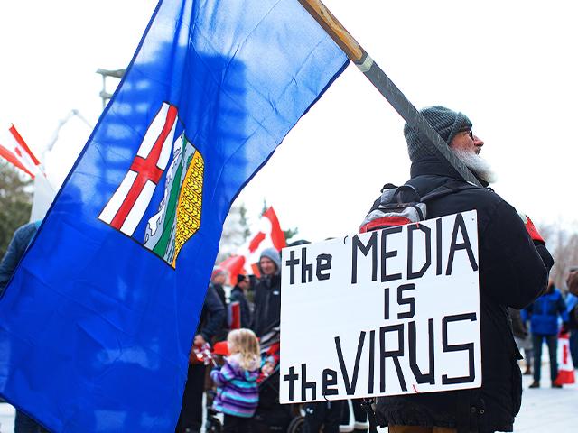 Protestors against COVID-19 restrictions attend a rally in support of a trucker convoy in Canada  (Jason Franson /The Canadian Press via AP)