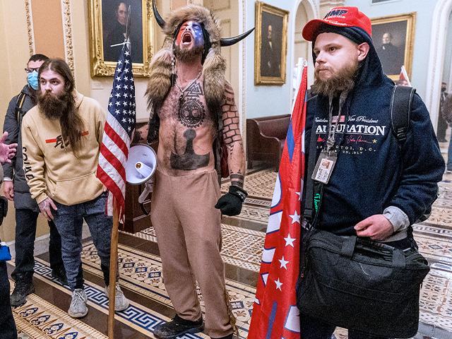 Rioters confronted by Capitol Police officers outside the Senate Chamber inside the Capitol, Wednesday, Jan. 6, 2021. (AP Photo/Manuel Balce Ceneta)