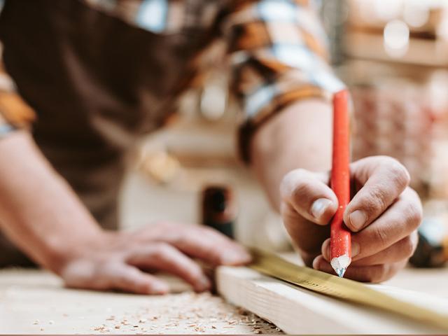 carpenter making measuring marks with a pencil