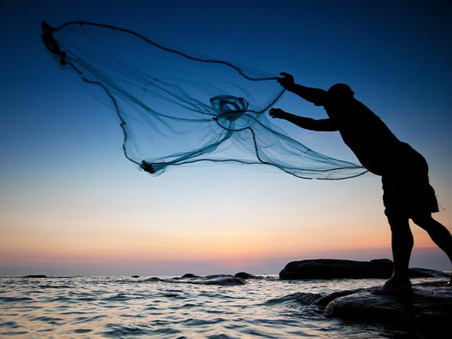 person casting a fishing net