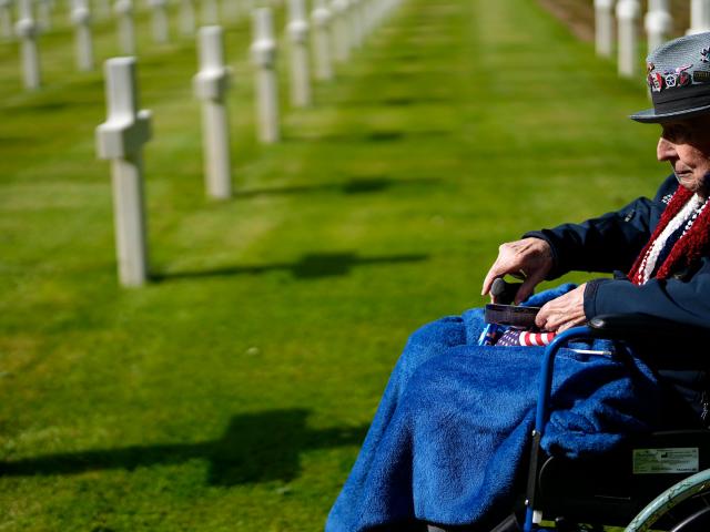 WW II and D-Day veteran Jake Larson visits the grave of a soldier from his unit at the Normandy American Cemetery in Colleville-sur-Mer, France, June 4, 2024. (AP Photo/Virginia Mayo)