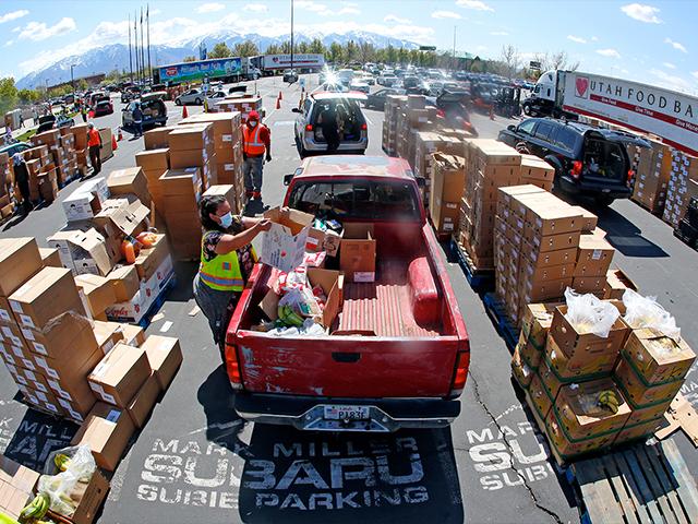 Cars line up for food at the Utah Food Bank&#039;s mobile food pantry at the Maverik Center, April 24, 2020, in West Valley City, Utah. As coronavirus concerns continue, the need for assistance has increased. (AP Photo/Rick Bowmer)