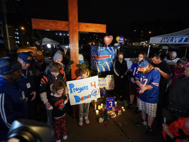 People pray during a prayer vigil for Buffalo Bills&#039; Damar Hamlin outside of University of Cincinnati Medical Center, Tuesday, Jan. 3, 2023, in Cincinnati. (AP Photo/Darron Cummings)