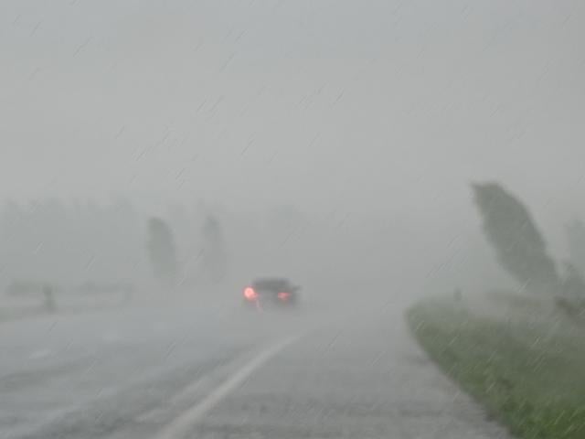 rain and wind blur car on highway