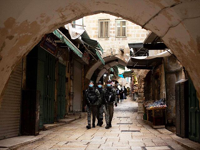 Israeli police patrol the Muslim Quarter of the Old City of Jerusalem, Friday, Jan. 15, 2021 during the country's third lockdown. (AP Photo/Maya Alleruzzo)