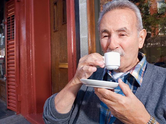 older man drinking espresso