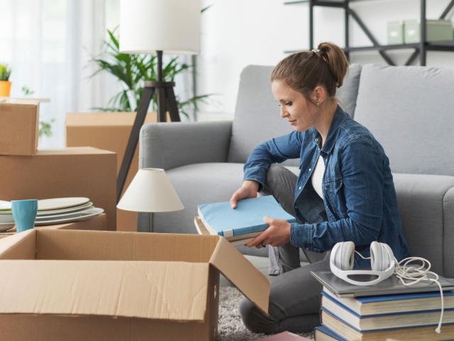A woman looking joyful while packing