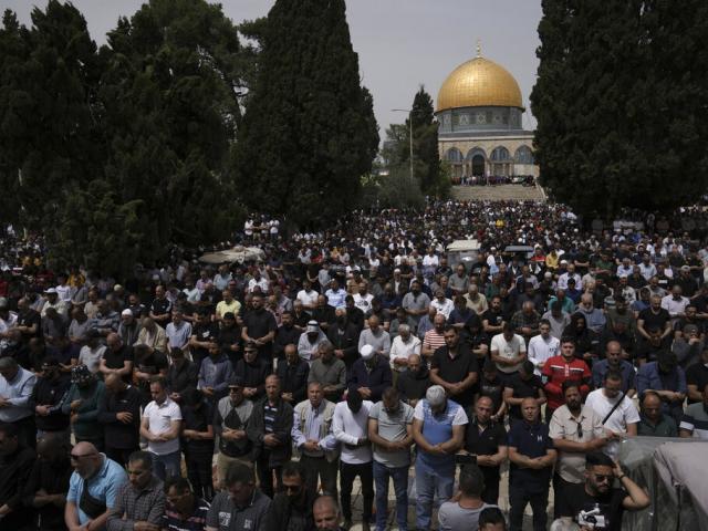 Palestinians pray during holy Islamic month of Ramadan in front of the Dome of the Rock shrine in Jerusalem, Friday, April 8, 2022. (AP Photo/Mahmoud Illean)