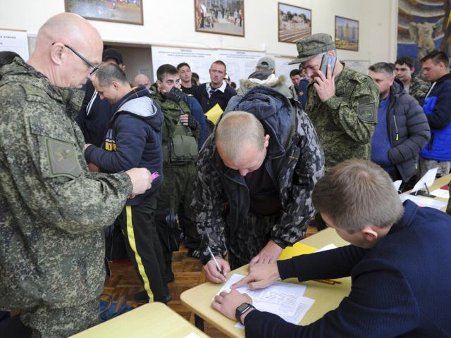 Russian recruits gather inside a military recruitment center of Bataysk, Rostov-on-Don region, south of Russia, Monday, Sept. 26, 2022. Russian President Vladimir Putin last Wednesday ordered a partial mobilization of reservists to beef up his forces in U