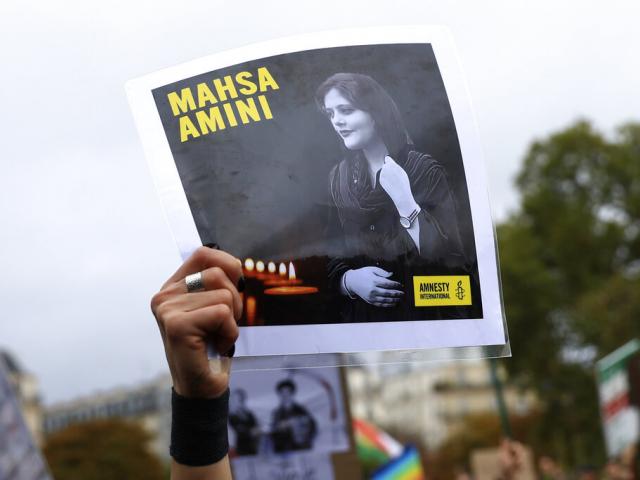  A portrait of Mahsa Amini during a demonstration to support Iranian protesters standing up to their leadership.  (AP Photo/Aurelien Morissard)