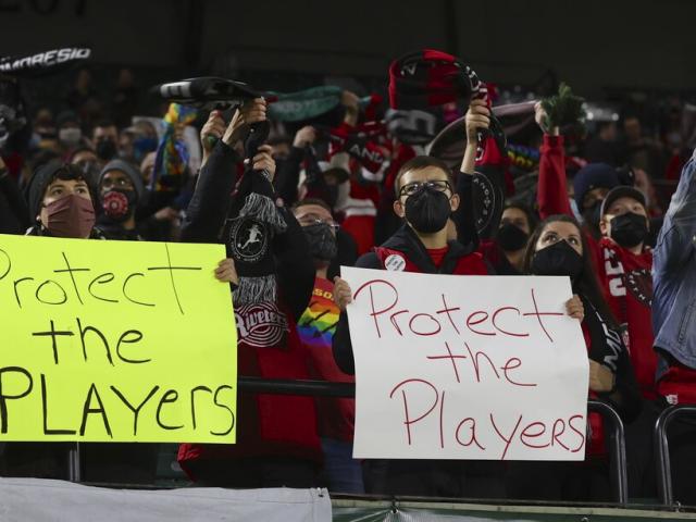 Portland Thorns fans hold signs during the first half of the team&#039;s NWSL soccer match against the Houston Dash in Portland, Ore., Wednesday, Oct. 6, 2021.  (AP Photo/Steve Dipaola, File) 