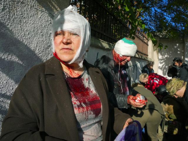 People receive medical treatment at the scene of Russian shelling, in Kyiv, Ukraine, Monday, Oct. 10, 2022  (AP Photo/Efrem Lukatsky )