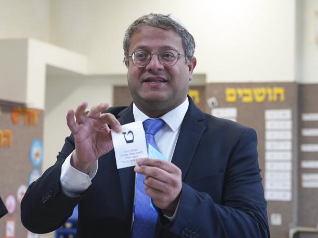 Israeli lawmaker Itamar Ben Gvir shows his ballot in the West Bank community of Kiryat Arba during Israeli elections, Tuesday, Nov. 1, 2022. (AP Photo/Tsafrir Abayov, File)