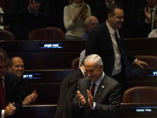 Israeli Prime Minister designate Benjamin Netanyahu, center, applauds Yariv Levin, off camera, after lawmakers voted to elect Levin as Speaker of the Knesset, Israel&#039;s parliament, in Jerusalem, Tuesday, Dec. 13, 2022. (AP Photo/ Maya Alleruzzo)