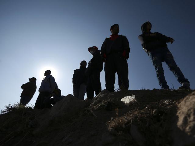 Migrants stand near the U.S.-Mexico border in Ciudad Juarez, Mexico, Monday, Dec. 19, 2022. Pandemic-era immigration restrictions in the U.S. known as Title 42 are set to expire on Dec. 21. (AP Photo/Christian Chavez)