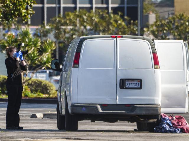  A forensic photographer takes pictures of a van&#039;s window and its contents in Torrance, Calif., Sunday, Jan. 22, 2023. A mass shooting took place at a dance club following a Lunar New Year celebration. (AP Photo/Damian Dovarganes)