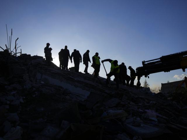 Rescue teams search for people in the rubble of destroyed buildings in Antakya, southern Turkey, Wednesday, Feb. 8, 2023. (AP Photo/Khalil Hamra)