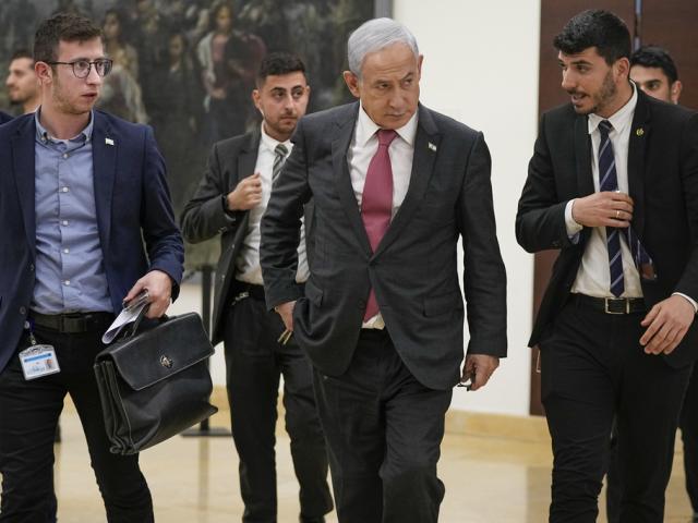 Israel&#039;s Prime Minister Benjamin Netanyahu walks at the Knesset in Jerusalem, Wednesday, March 15, 2023. The security situation in Israel prompted Netanyahu to cut short his visit to Germany, his office said. (AP Photo/Ohad Zwigenberg) 