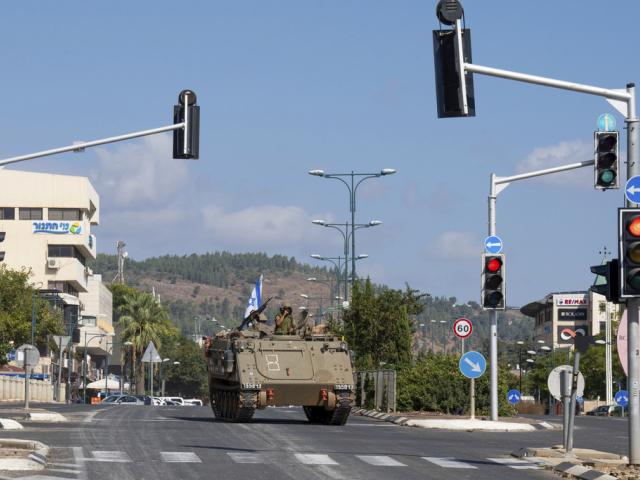 Israeli soldiers drive an armored personal carrier (APC) in the northern Israeli city of Kiryat Shmona, Friday, Oct. 20, 2023. The Israeli military announced Friday it would evacuate Kiryat Shmona, a city close to the border with Lebanon. Three residents were injured Thursday after the town came under cross-border fire from militants in Lebanon. (AP Photo/Baz Ratner)