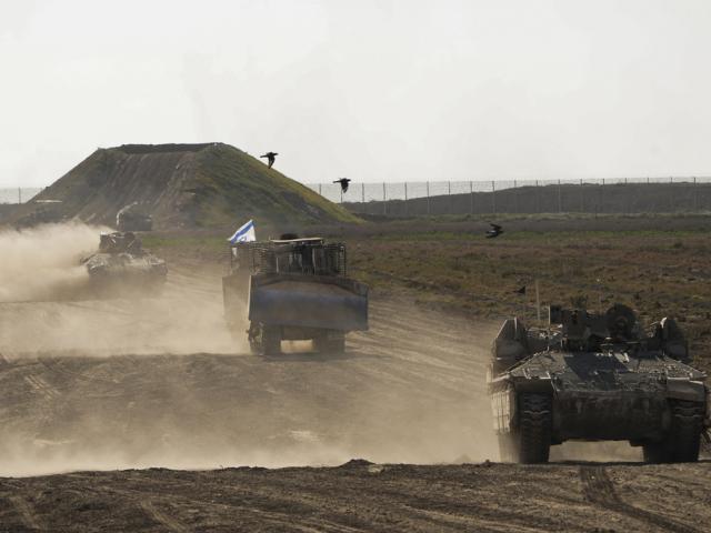 Israeli troops move near the Gaza Strip border in southern Israel, Monday, March 4, 2024. (AP Photo/Ohad Zwigenberg, File)