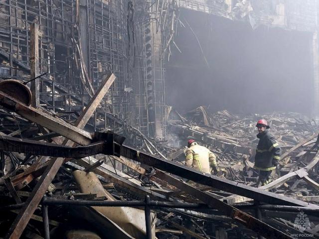 In this photo released by Russian Emergency Ministry Press Service on Saturday, March 23, 2024, firefighters work in the burned concert hall after an attack on the building of the Crocus City Hall, Moscow, Russia. (Russian Emergency Press Service via AP).