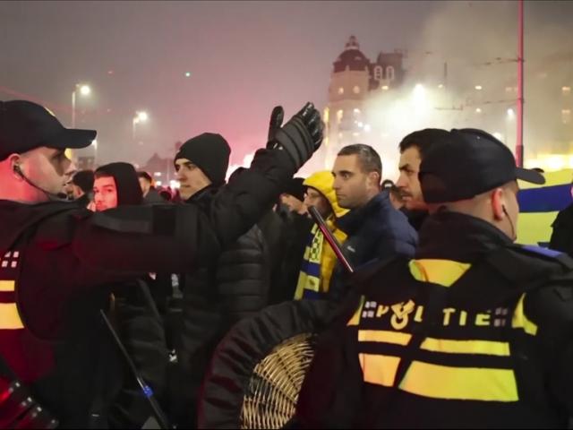 Police escort Maccabi Tel Aviv supporters to the metro station leading them to the Ajax stadium, after pro-Palestinian supporters marched near the stadium, in Amsterdam, the Netherlands, Thursday, Nov. 7, 2024. (AP Photo InterVision)