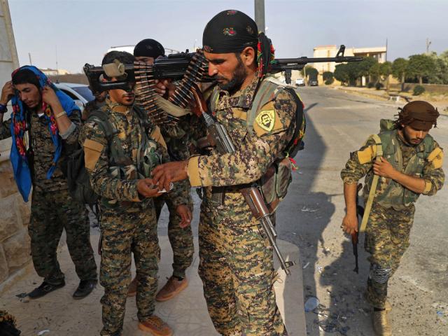 Kurdish-led fighters backed by the U.S. prepare for battle against Islamic state group militants, in Raqqa, Syria, on June 22, 2017. (AP Photo/Hussein Malla, File)