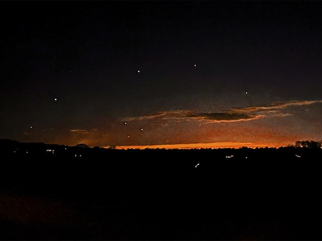 This photo provided by Trisha Bushey shows the evening sky and points of light near in Lebanon Township, N.J., on Thursday, Dec. 5, 2024. (Trisha Bushey via AP)