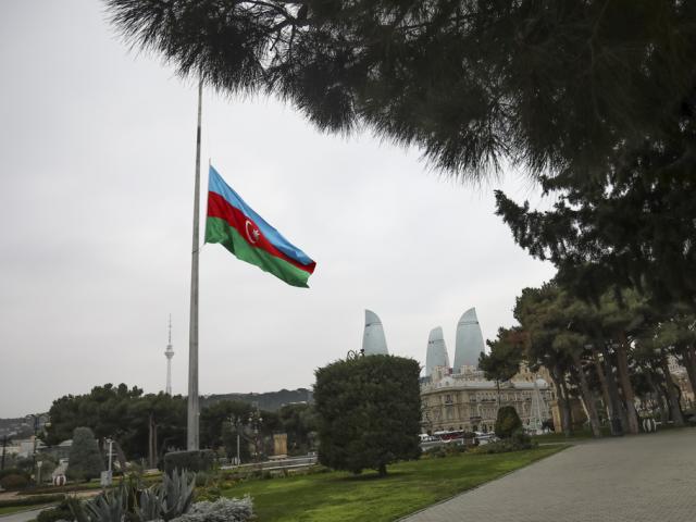 Azerbaijan&#039;s national flag at half-mast in the memory of victims of the Azerbaijan Airlines&#039; Embraer 190 that crashed near the Kazakhstan&#039;s airport of Aktau, is seen in the center of Baku, Azerbaijan, Thursday, Dec. 26, 2024. (AP Photo/Aziz Karimov)