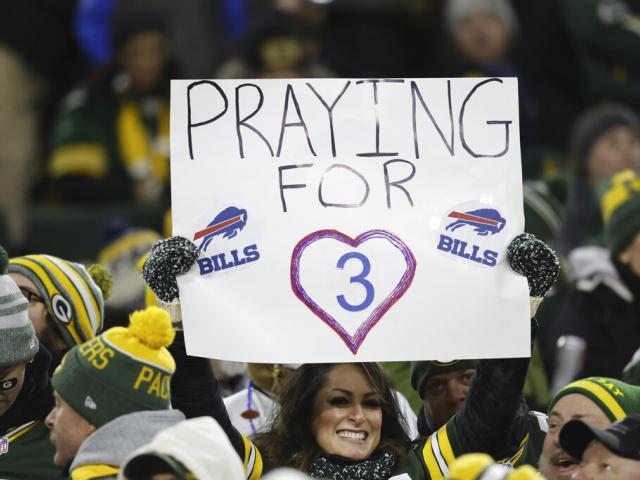 A fan holds a sign of support for injured Buffalo Bills safety Damar Hamlin during an NFL football game, Jan. 8, 2023, in Green Bay, Wis. (AP Photo/Jeffrey Phelps)