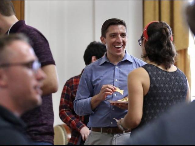 Zak Ringlestein, center, a Democratic candidate for the U.S. Senate, a potluck dinner prior to a meeting of the Southern Maine Democratic Socialists of America at City Hall in Portland, Maine.  