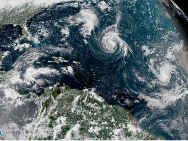 This enhanced satellite image made available by NOAA, shows Tropical Storm Florence, center, in the Atlantic Ocean on Saturday.