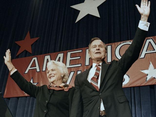 In this Nov. 8, 1988 file photo, President-elect George H.W. Bush and his wife Barbara wave to supporters in Houston, Texas after winning the presidential election. AP Photo.