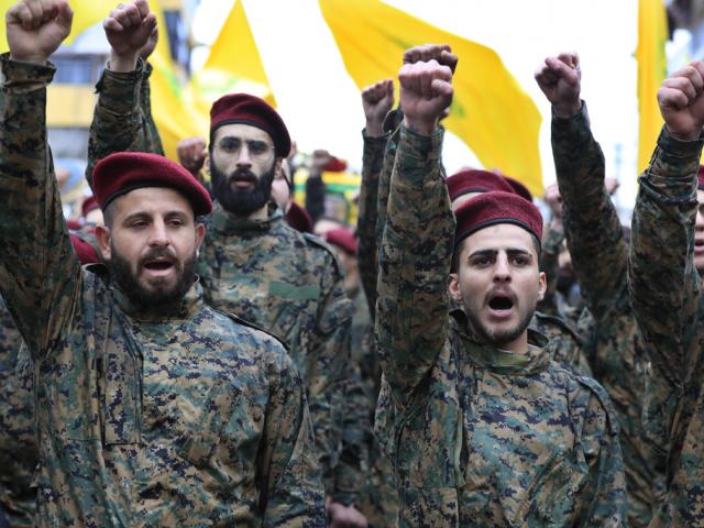 Hezbollah fighters raise their fists after Israel&#039;s military said it killed a senior commander with the jihadist group&#039;s elite Radwan Force (AP Photo/Mohammed Zaatari)