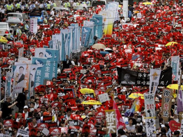 Protesters march along a downtown street against the proposed amendments to an extradition law in Hong Kong Sunday, June 9, 2019. (AP Photo/Vincent Yu) 