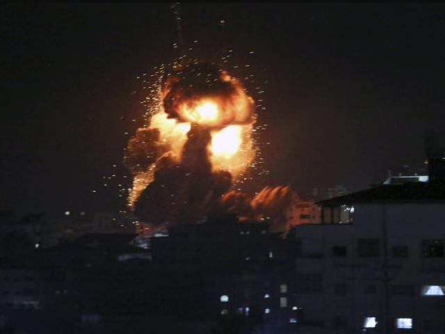 An explosion caused by Israeli airstrikes is seen from the offices of Hamas leader Ismail Haniyeh, in Gaza City, Monday, March 25, 2019.  (AP Photo/Adel Hana) 