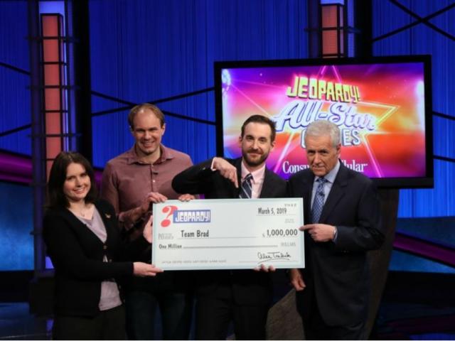 This photo provided by Sony shows Brad Rutter, Larissa Kelly and David Madden with Alex Trebek, winners of the first-ever &quot;Jeopardy!&quot; team championship, Tuesday, March 5, 2019 in in Burbank, Calif. (Carol Kaelson /Sony via AP)