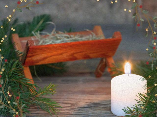 Peaceful candle by a manger 