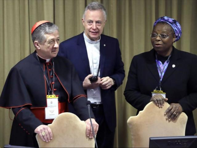 Sister Veronica Openibo, right, stands next to Chicago Archbishop Cardinal Blase J. Cupich, left, and Father Tomaz Mavric, center. (AP Photo/Alessandra Tarantino, Pool)