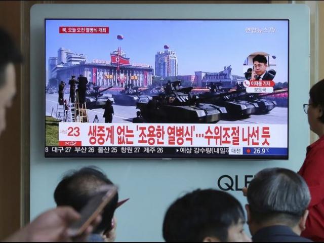 People watch a TV screen showing a parade for the 70th anniversary of North Korea&#039;s founding day in the Seoul Railway Station in Seoul, South Korea. 
