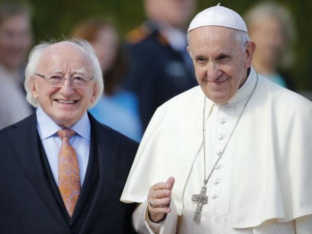 Pope Francis, right, is flanked by Irish President Michael D. Higgins, upon his arrival at the Presidential residence in Dublin, Ireland, on Saturday.