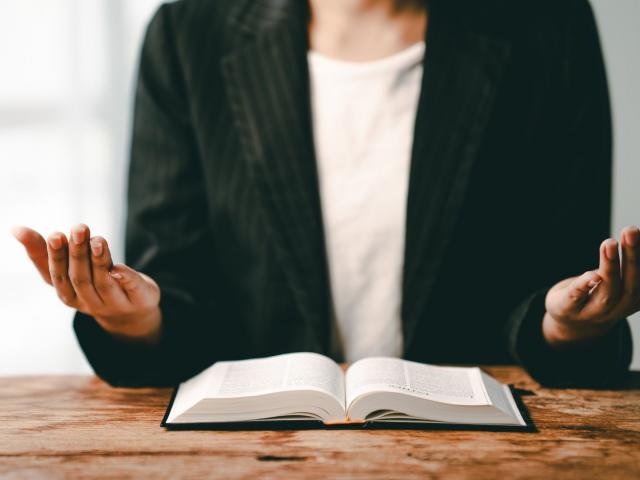woman holding a Bible hands in prayer